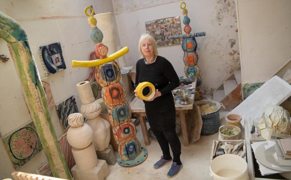 Sandy Brown next to a scale model of the 10.5m ceramic artwork in her studio last year.