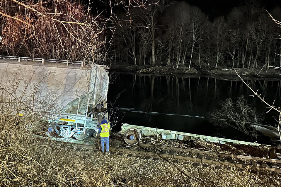 In this image provided by New York State Department of Environmental Conservation, train crews and first responders walk the site of a train derailment, Wednesday evening, Feb. 7, 2024, in Valley Falls, N.Y. Authorities say 10 cars of a 94-car cargo train carrying plastic pellets and cooking oil, derailed in upstate New York, with two ending up in a river. (Basil Seggos/ New York State Department of Environmental Conservation via AP)