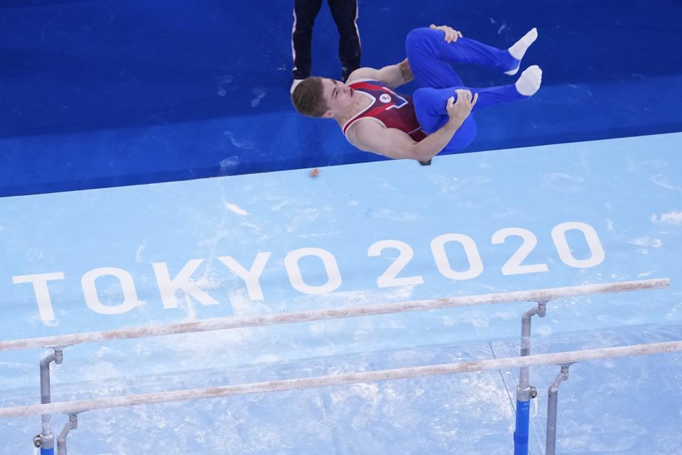 Aleksandr Kartsev, of Russian Olympic Committee, performs on the parallel bars during men's artistic gymnastics qualifications at the 2020 Summer Olympics, Saturday, July 24, 2021, in Tokyo. (AP Photo/Morry Gash)