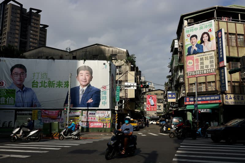 FILE PHOTO: Traffic can be seen with the backdrop of election campaign posters in Taipei