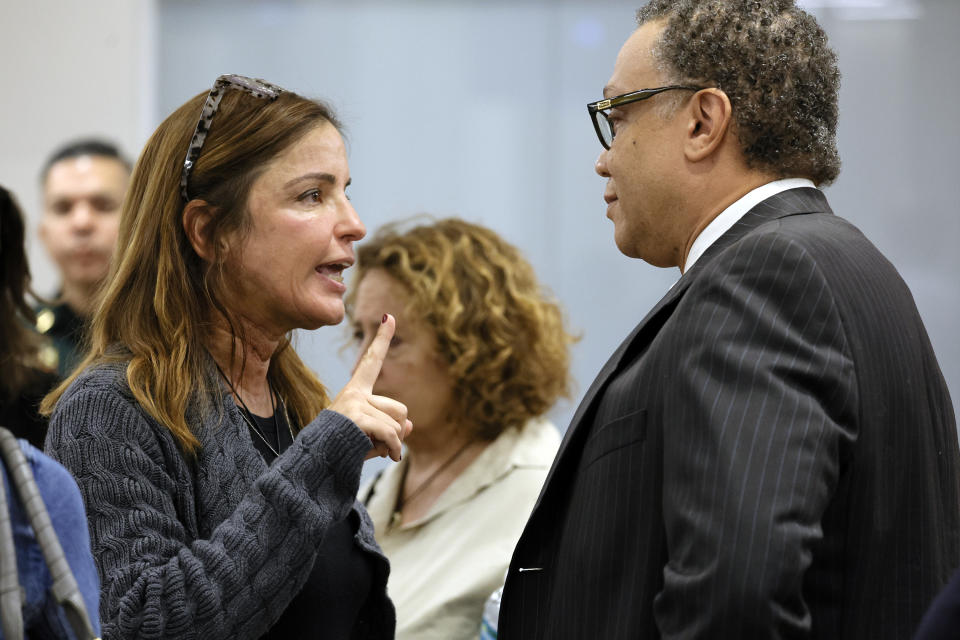 Patricia Padauy Oliver speaks with Broward County Public Defender Gordon Weekes during a break in the sentencing hearing for Marjory Stoneman Douglas High School shooter Nikolas Cruz at the Broward County Courthouse in Fort Lauderdale, Fla. on Tuesday, Nov. 1, 2022. Padauy Oliver's son, Joaquin Oliver, was killed in the 2018 shootings. Cruz was sentenced to life in prison for murdering 17 people at Parkland's Marjory Stoneman Douglas High School more than four years ago. (Amy Beth Bennett/South Florida Sun Sentinel via AP, Pool)