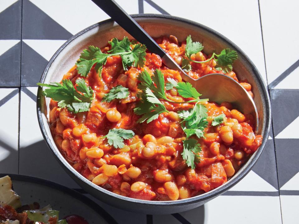 <p>The standard backyard-barbecue side takes a global turn with warm spices, but the beans are still perfectly at home alongside burgers and hot dogs.</p> <p><a href="https://www.myrecipes.com/recipe/indian-dal-baked-beans" rel="nofollow noopener" target="_blank" data-ylk="slk:Indian Dal Baked Beans Recipe;elm:context_link;itc:0;sec:content-canvas" class="link ">Indian Dal Baked Beans Recipe</a></p>