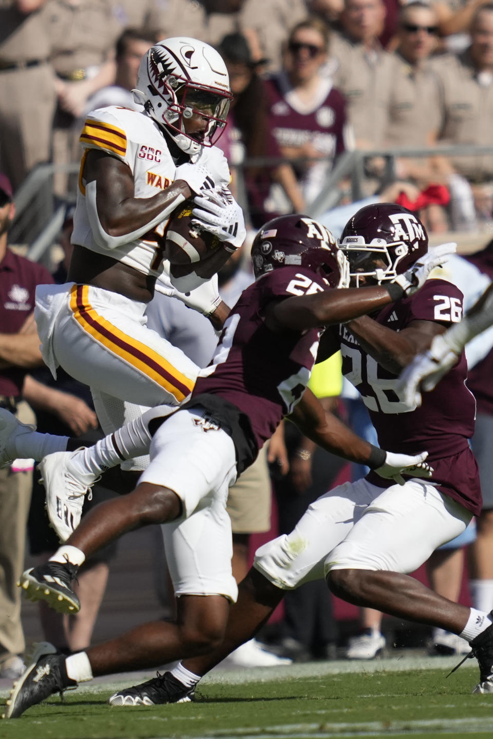 Louisiana-Monroe wide receiver Tyrone Howell, left, makes a catch for a gain as Texas A&M defensive backs Josh DeBerry (28) and Demani Richardson (26) defend during the second quarter of an NCAA college football game Saturday, Sept. 16, 2023, in College Station, Texas. (AP Photo/Sam Craft)