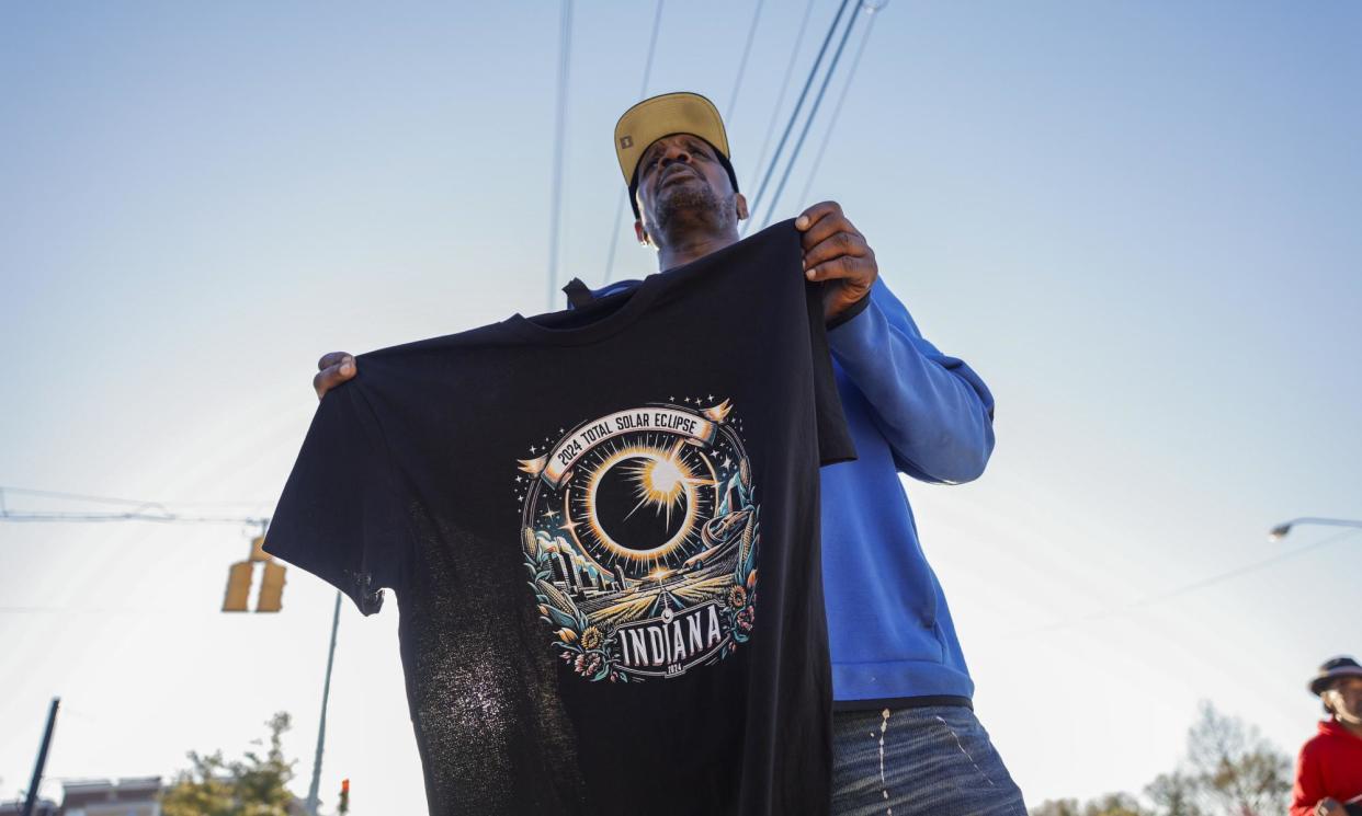 <span>A souvenir seller offering eclipse T-Shirts in Bloomington, Indiana, on Saturday. </span><span>Photograph: Jeremy Hogan/SOPA Images/REX/Shutterstock</span>