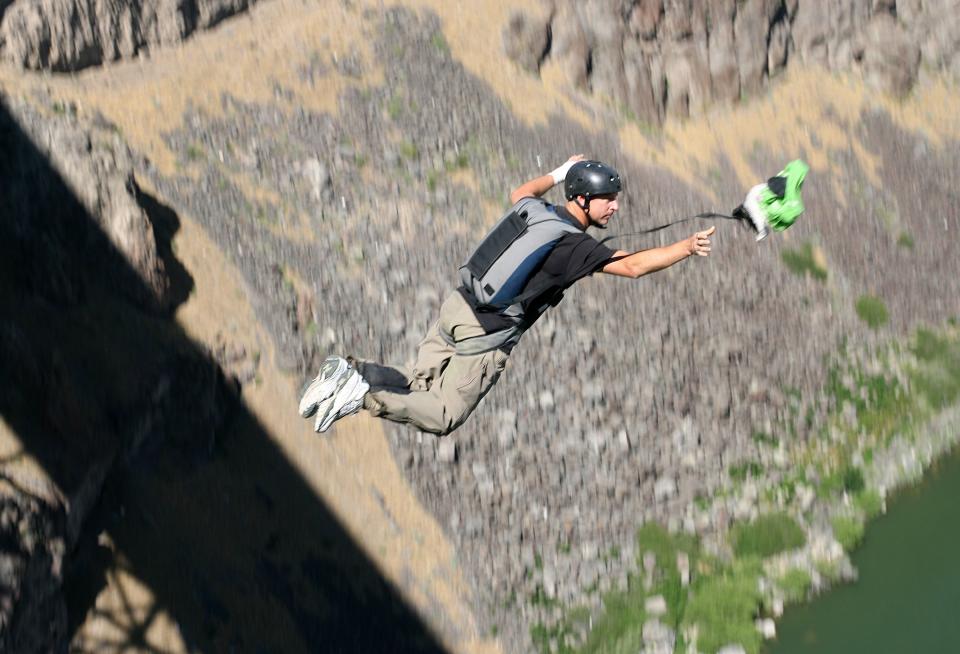 Air National Guard Capt. Dan Schilling leaps off the Perrine Bridge Saturday, July 8, 2006, in Twin Falls, Idaho. The military parachutist set a new world record for BASE jumping by jumping 201 times in 24 hours. | Meagan Thompson, South Idaho Press via Associated Press