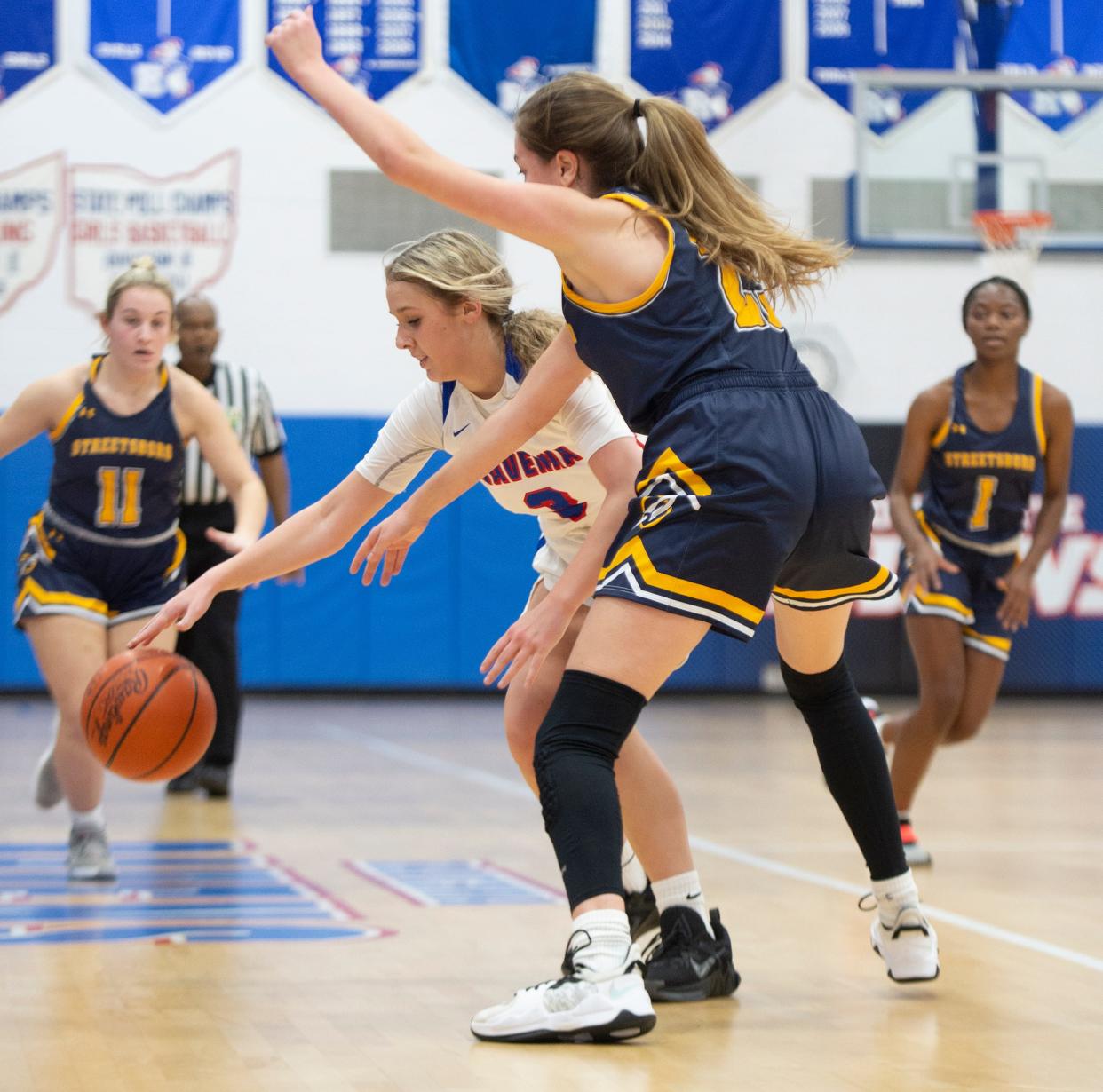 Ravenna's Breena Kainrad dribbles against Streetsboro's Ella Kassan during the 2021-2022 season.