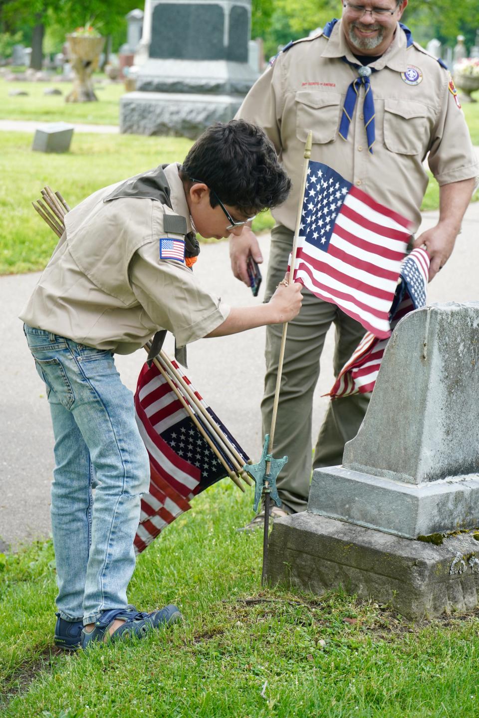 Sturgis American Legion teamed with Veterans of Foreign Wars and Girl and Boy scouts Thursday to place flags at Oak Lawn Cemetery in Sturgis, in advance of Memorial Day.