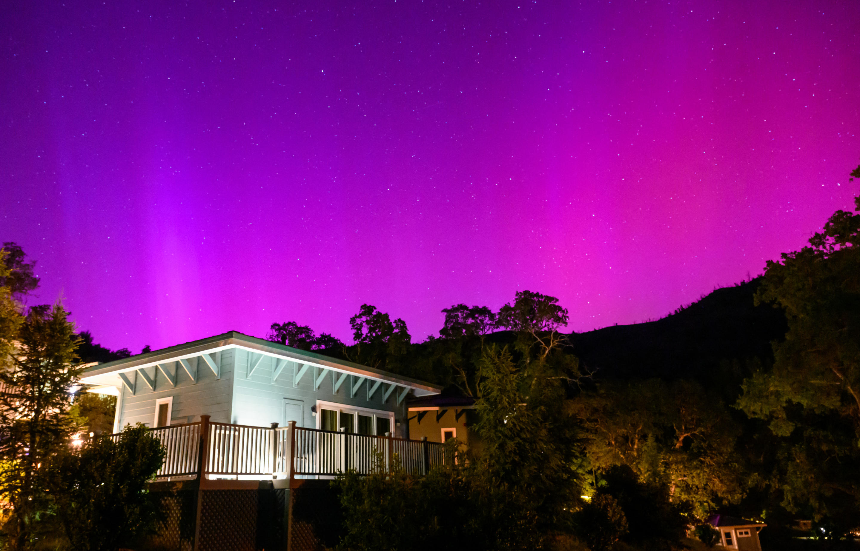 Northern lights or aurora borealis illuminate the night sky over a camper's tent north of San Francisco in Middletown, California on May 11, 2024. The most powerful solar storm in more than two decades struck Earth, triggering spectacular celestial light shows from Tasmania to Britain -- and threatening possible disruptions to satellites and power grids as it persists into the weekend. (Photo by JOSH EDELSON / AFP) (Photo by JOSH EDELSON/AFP via Getty Images)