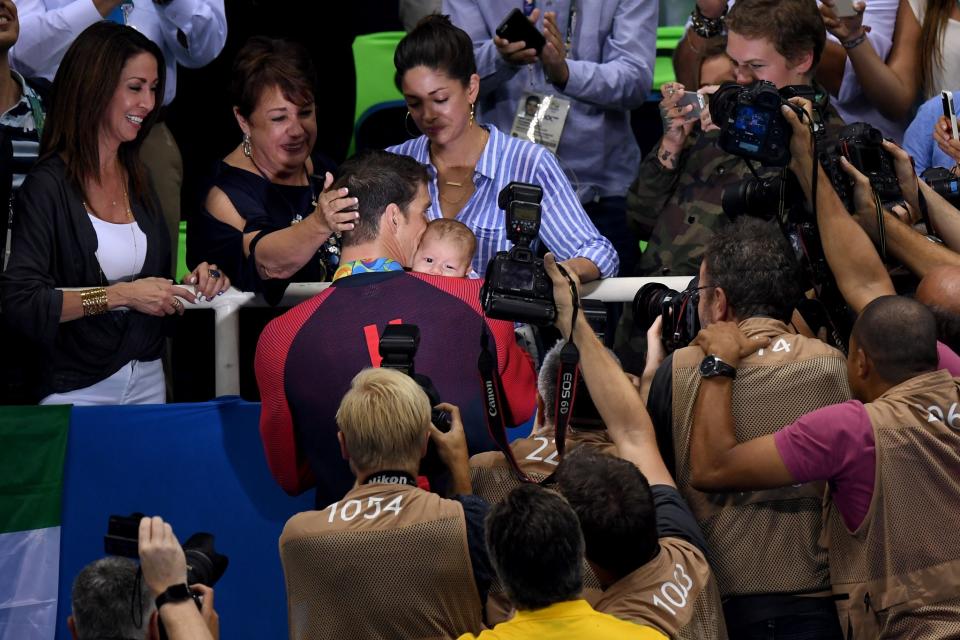 <p>Gold medalist Michael Phelps of the United States celebrates with his mother Deborah Phelps, fiancee Nicole Johnson and son Boomer during the medal ceremony for the Men’s 200m Butterfly Final on Day 4 of the Rio 2016 Olympic Games at the Olympic Aquatics Stadium on August 9, 2016 in Rio de Janeiro, Brazil. (Photo by David Ramos/Getty Images) </p>