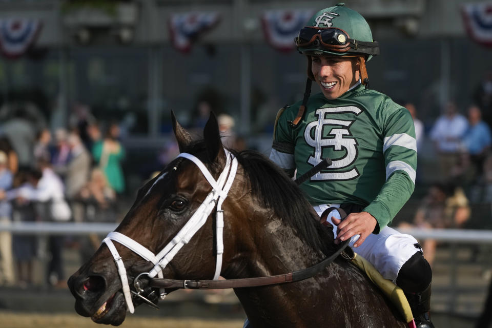 Jockey Irad Ortiz, atop Up to the Mark, smiles after winning The Resorts World Casino Manhattan horse race ahead of the Belmont Stakes horse race, Saturday, June 10, 2023, at Belmont Park in Elmont, N.Y. (AP Photo/Seth Wenig)