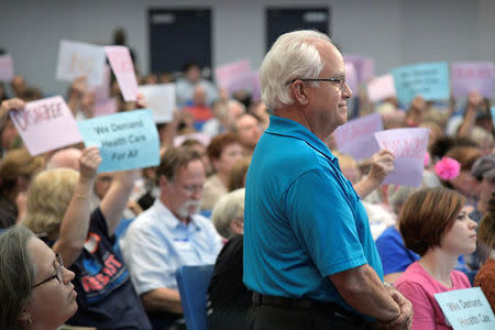 Business owner John Pastore asks U.S. Representative Ted Yoho (R-FL) to repeal Obamacare as other attendees react during a town hall meeting in Gainesville, Florida, U.S., April 10, 2017. REUTERS/Phelan Ebenhack