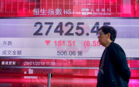Asian markets were lower on Tuesday after the U.S. Justice Department unsealed criminal charges against China's Huawei - Credit: AP