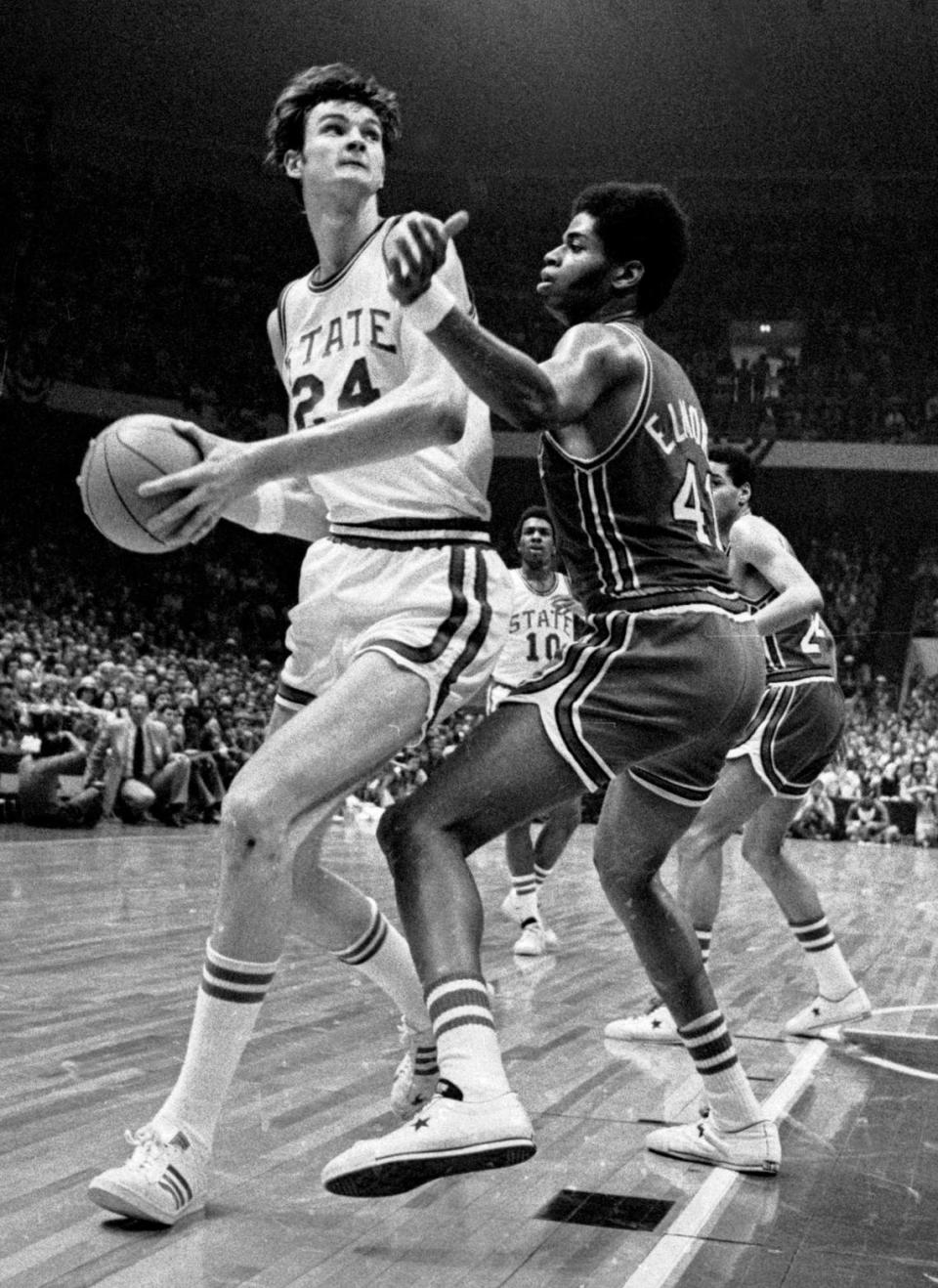 NC State center Tommy Burleson drives against Maryland center Len Elmore in the 1974 ACC Tournament championship game.