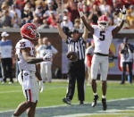 Georgia tailback Brian Herrien scores while teammate Matt Landers and the official signal the touchdown for the early 10-0 lead over Georgia Tech during the first quarter in a NCAA college football game on Saturday, November 30, 2019, in Atlanta. (Curtis Compton/Atlanta Journal-Constitution via AP)
