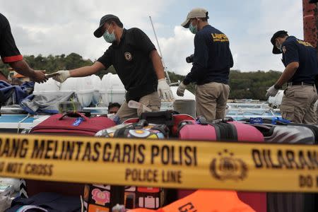 A police forensic team examines a ferry boat which was carrying tourists from the island of Bali to Lombok following an explosion on board, at Padangbai port, Bali, Indonesia September 15, 2016 in this photo taken by Antara Foto. Antara Foto/Nyoman Budhiana /via REUTERS