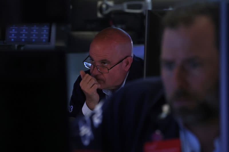 Traders work on the floor of the NYSE in New York