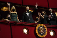 President Joe Biden and first lady Jill Biden wave as they arrive at the 44th Kennedy Center Honors at the John F. Kennedy Center for the Performing Arts in Washington, Sunday, Dec. 5, 2021. Vice President Kamala Harris, and second gentleman Doug Emhoff, applaud at right. The 2021 Kennedy Center honorees include Motown Records creator Berry Gordy, "Saturday Night Live" mastermind Lorne Michaels, actress-singer Bette Midler, opera singer Justino Diaz and folk music legend Joni Mitchell. (AP Photo/Carolyn Kaster)