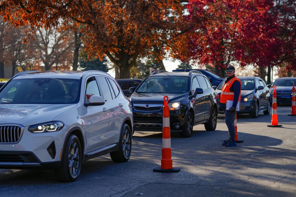 Shawn Prather, of Hebron, Kentucky, directs traffic during a Freestore Foodbank drive-through holiday meal distribution in Roselawn in November 2023.