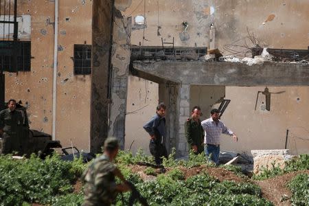 Government forces surrender themselves to Kurdish fighters in the city of Qamishli, Syria. REUTERS/Rodi Said