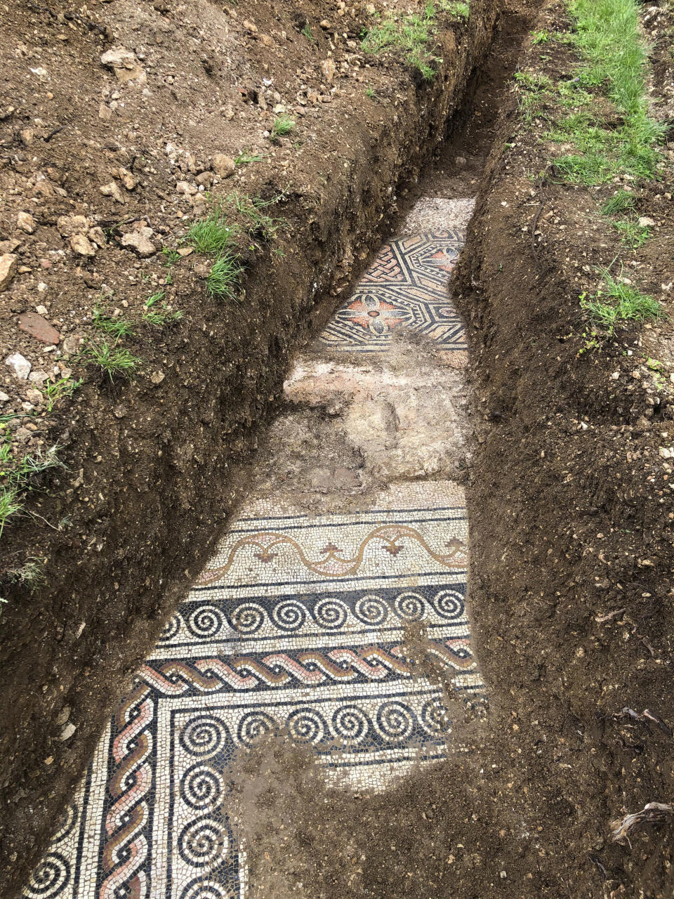 A view of a well-preserved colorful mosaic floor of an ancient Roman villa archaeologists have revealed among vineyards near the northern city of Verona, Italy. The official in charge of archaeology Verona province, Gianni De Zuccato, on Friday, May 29, 2020, said the mosaics appeared to be ‘’in a good state of conservation,’’ from what they are able to observe after gingerly digging a trench between vineyards in the hills of Valpolicella, known for its full-bodied red wine. (Soprintendenza ABAP Verona via AP)