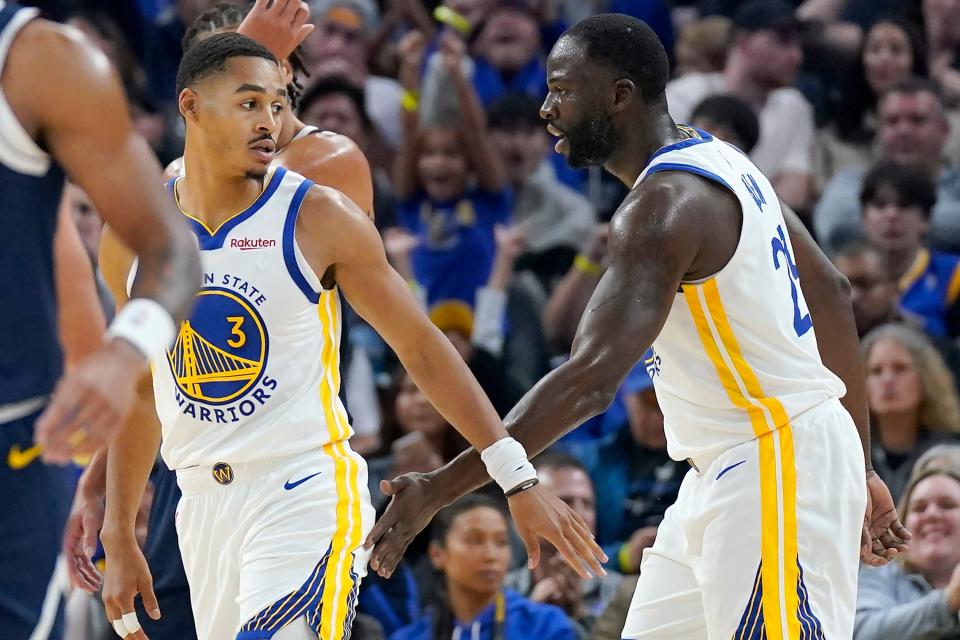 Golden State Warriors guard Jordan Poole (3) is congratulated by forward Draymond Green after scoring against the Denver Nuggets during the first half of an NBA preseason basketball game in San Francisco, Friday, Oct. 14, 2022. (AP Photo/Jeff Chiu)