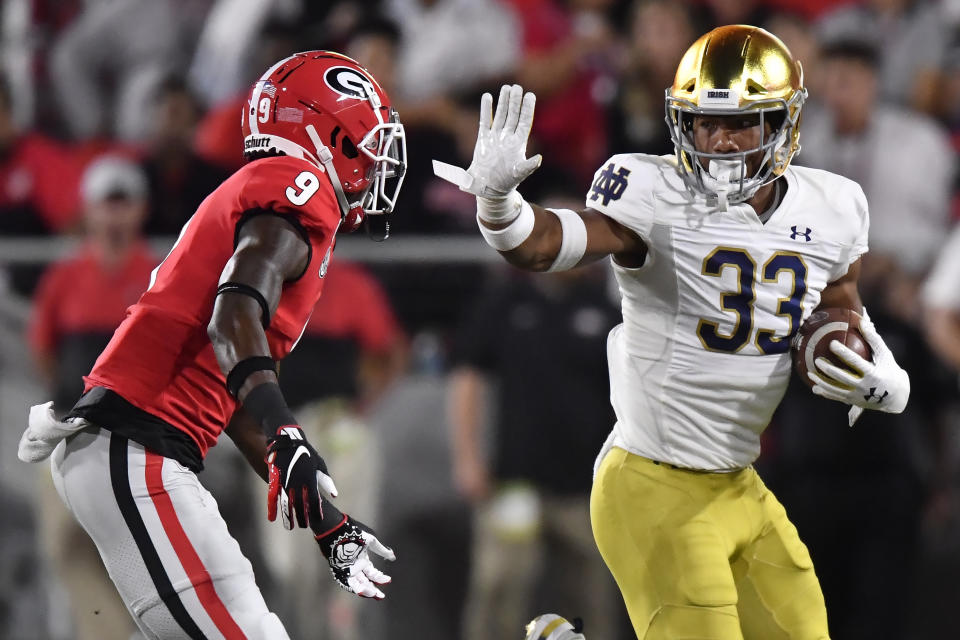 Notre Dame linebacker Shayne Simon (33) runs against Georgia defensive back Ameer Speed (9) during the second half of an NCAA college football game, Saturday, Sept. 21, 2019, in Athens, Ga. Georgia won 23-17. (AP Photo/Mike Stewart)