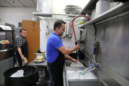 Mauricio Felix, 38, (R) washes dishes with Alejandro Galindo, 42, in his family's restaurant, Rancho Grande, in Nogales, Arizona, U.S., January 31, 2017. REUTERS/Lucy Nicholson