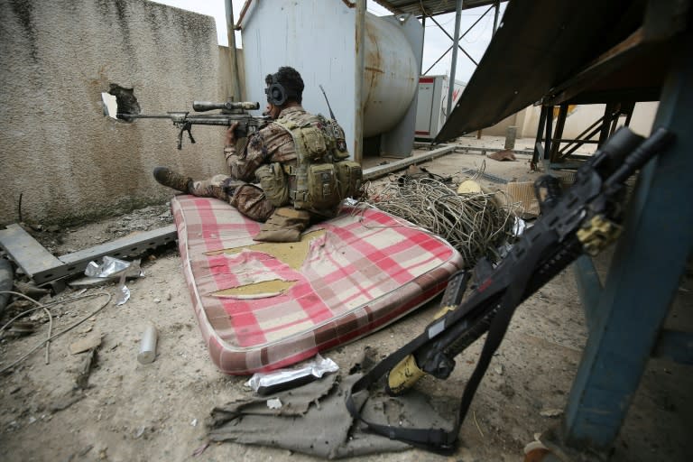 An Iraqi forces sniper takes aim as federal police and the elite Rapid Response Division battle to take the Old City in west Mosul from jihadists