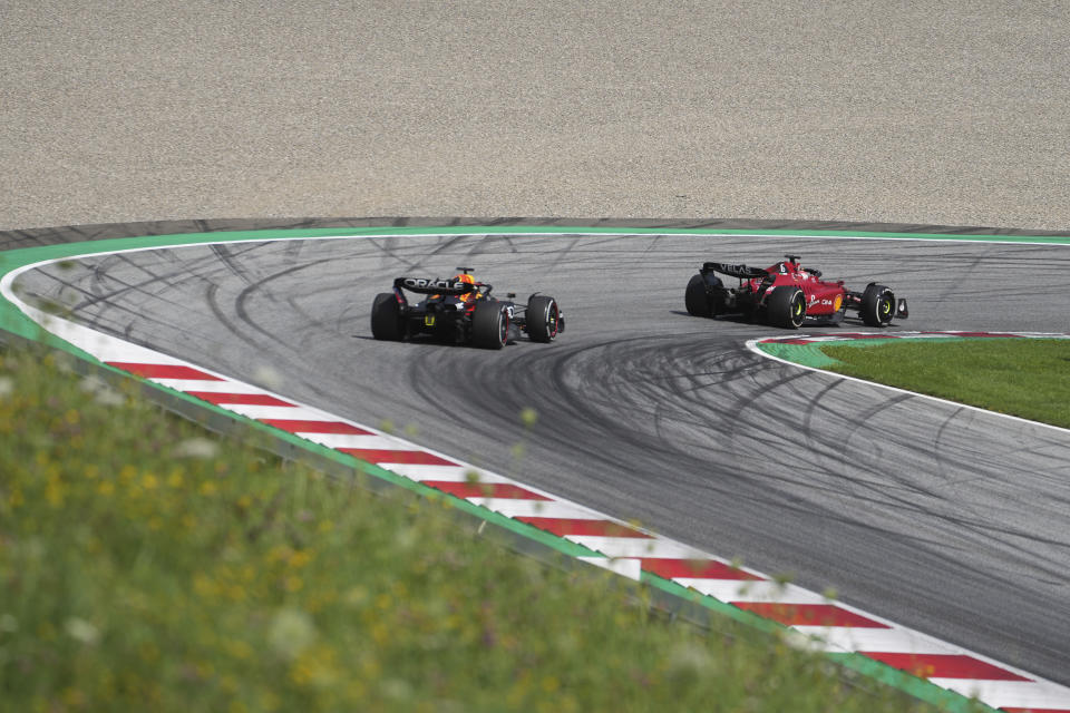 Ferrari driver Charles Leclerc, right, of Monaco, steers his car followed by Red Bull driver Max Verstappen, of the Netherlands, during the Austrian F1 Grand Prix at the Red Bull Ring racetrack in Spielberg, Austria, Sunday, July 10, 2022. (AP Photo/Matthias Schrader)