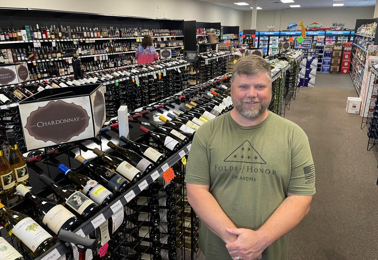 Clint Wilson is shown in Whiskey Cabinet Oklahoma, the wine, beer and spirits store he and his wife, Kyla, own and operate at 2300 W Danforth Road, No. 110, in Edmond. The Wilsons say a national liquor store chain, if allowed to open in Oklahoma, will wipe out mom-and-pop shops like theirs.