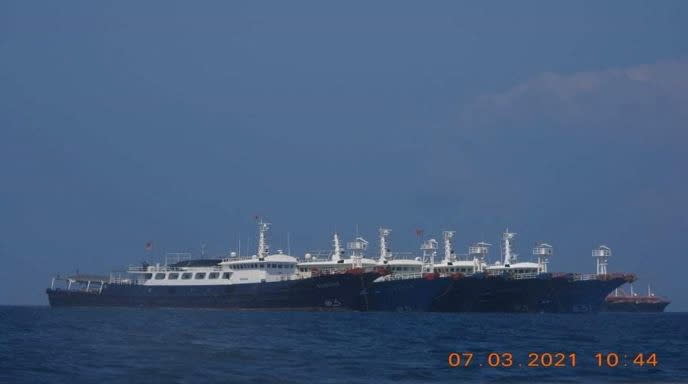 Some of the about 220 vessels reported by the Philippine Coast Guard are pictured at Whitsun Reef, South China Sea