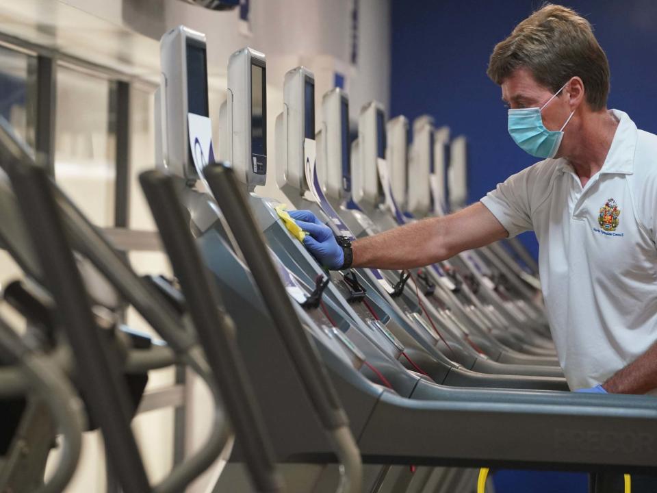 David Silver, a fitness and rehab instructor, cleans down gym machines at the North Tyneside Council Waves Gym: PA