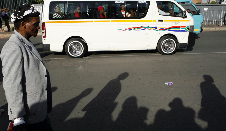 Pedestrians walks on the street in Johannesburg, South Africa, on Tuesday Oct. 30, 2012. The results from the 2011 census are released Tuesday Oct. 30, 2012, showing that more households have access to basic services such as clean water and electricity, but a significant number continue to lag behind as the ruling party struggles to reduce the widening gap between the rich and the poor. (AP Photo/Themba Hadebe)