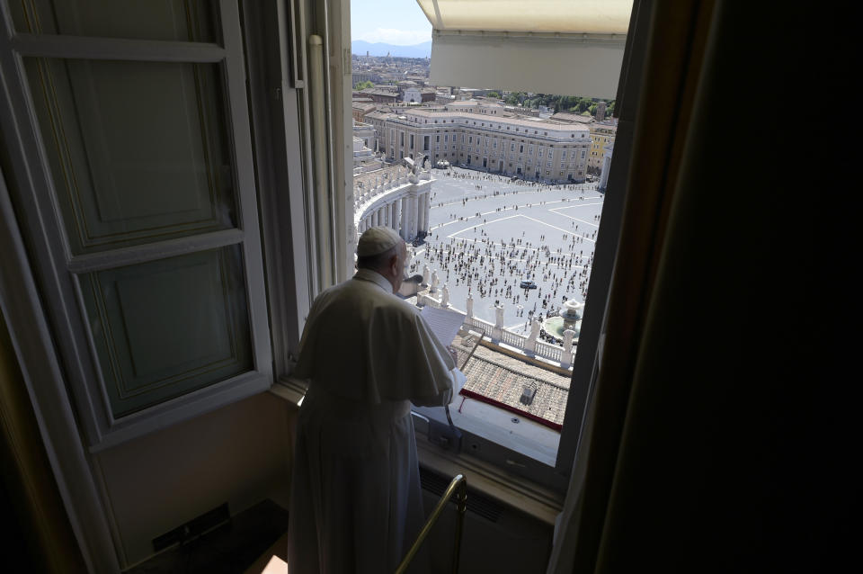 Pope Francis reads his message from his studio window overlooking St. Peter's Square at the Vatican, Sunday, May 31, 2020. Francis celebrated a Pentecost Mass in St. Peter's Basilica on Sunday, albeit without members of the public in attendance. He will then went to his studio window to recite his blessing at noon to the crowds below. The Vatican says police will ensure the faithful gathered in the piazza keep an appropriate distance apart. (Vatican News via AP)
