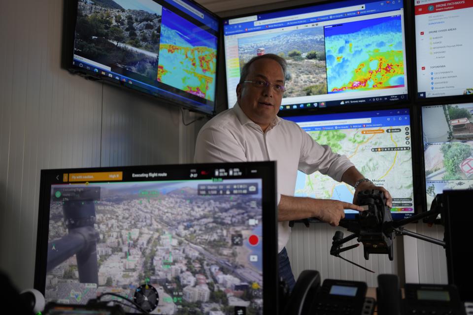 Grigoris Konstantellos, a commercial airline pilot and mayor of the southern Athens seaside suburbs of Vari, Voula and Vouliagmeni, shows a long-range drone equipped with thermal imaging cameras and a sophisticated early warning system, at the control room in Voula, Athens, Greece, Friday, Aug. 11, 2023. Greece is plagued by hundreds of wildfires each summer. To protect their area from potentially deadly blazes, a group of residents from a suburb in northern Athens have joined forces to hire a company using long-range drones equipped with thermal imaging cameras and a sophisticated early warning system to catch fires before they can spread. (AP Photo/Thanassis Stavrakis)