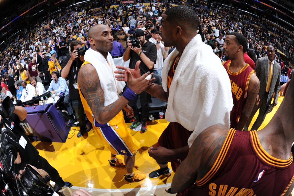 Kobe Bryant and LeBron James exchange a hug after their final matchup during Kobe’s farewell season. (Getty Images)