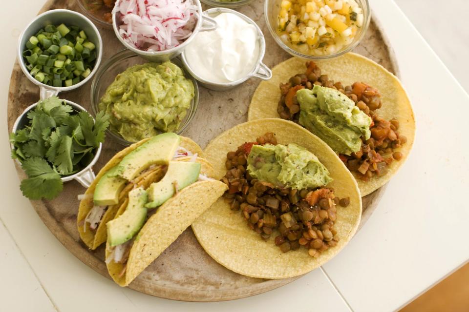 In this image taken on May 13, 2013, pulled pork tacos, left, and lentil tacos are served on a plate as seen in Concord, NH. (AP Photo/Matthew Mead)