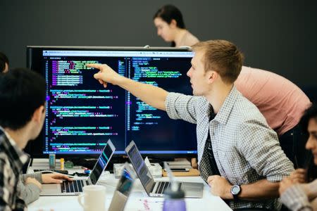 People work on computers at the Flatiron School in New York City, U.S., November 13, 2014. Courtesy of the Flatiron School/Handout via REUTERS