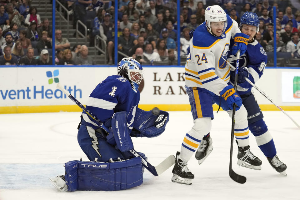 Tampa Bay Lightning goaltender Brian Elliott (1) makes a save on a deflected shot by Buffalo Sabres center Dylan Cozens (24) during the first period of an NHL hockey game Saturday, Nov. 5, 2022, in Tampa, Fla. (AP Photo/Chris O'Meara)