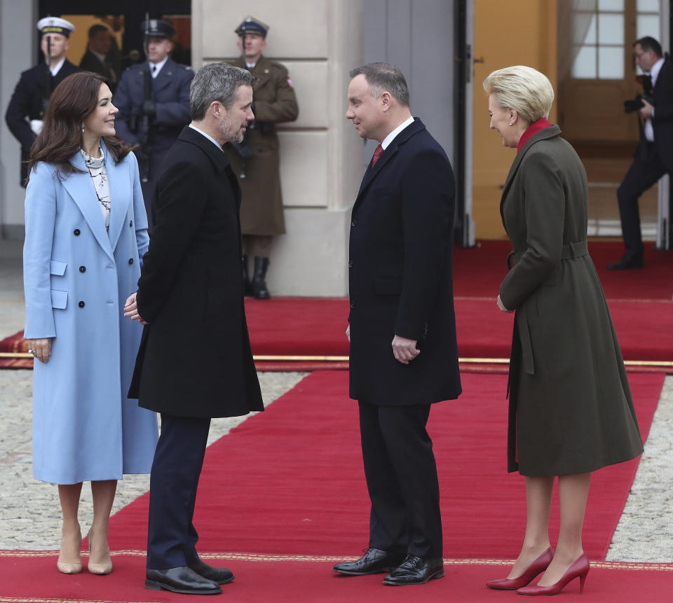 Denmark's Crown Princess Mary, left, and Crown Prince Frederik, second from left, welcome by Poland's President Andrzej Duda, second from right, and his wife Agata Kornhauser-Duda, right, during the welcoming ceremony at the start of their one-day visit marking 100 years of bilateral relations, in the Presidential Palace in Warsaw, Poland, Monday, Nov. 25, 2019. (AP Photo/Czarek Sokolowski)