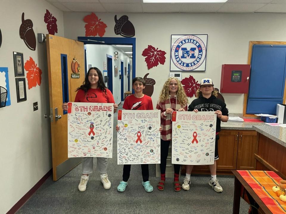 From left, Madison Middle School students Letty, Abel, Meredith and Calvin pose with signs during Red Ribbon Week.