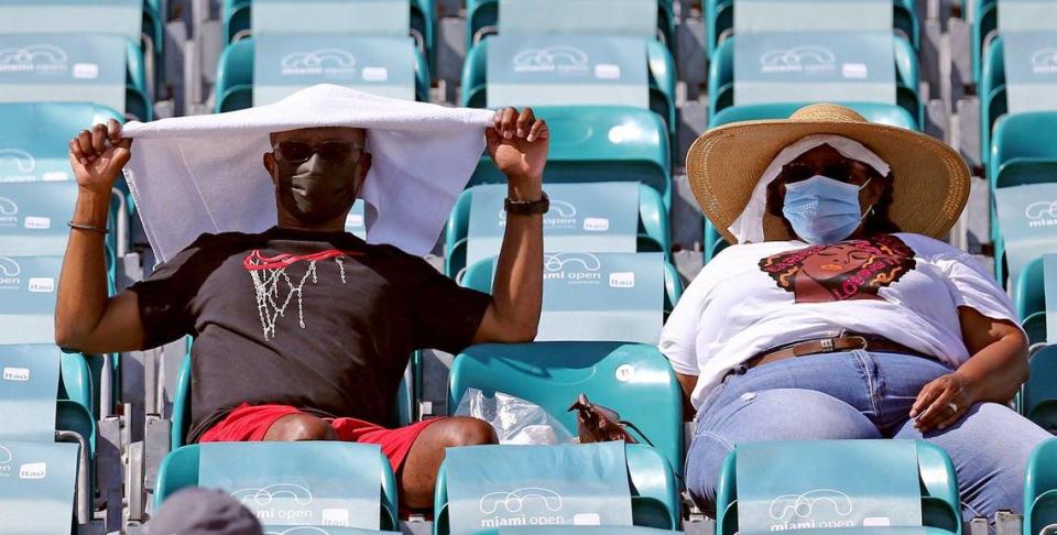 Fans shade themselves from the heat and sun during the 2021 Miami Open quarterfinals at Hard Rock Stadium in Miami Gardens on March 31, 2021.