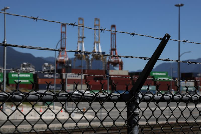 Containers and shipping cranes lie idle at the Port of Vancouver