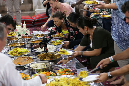 Foreign visitors and residents in the UAE eat an Emirati Iftar meal during the Muslim holy fasting month of Ramadan, at Sheikh Mohammed Centre for Cultural Understanding (SMCCU) in Dubai, UAE May 17, 2019. REUTERS/Satish Kumar