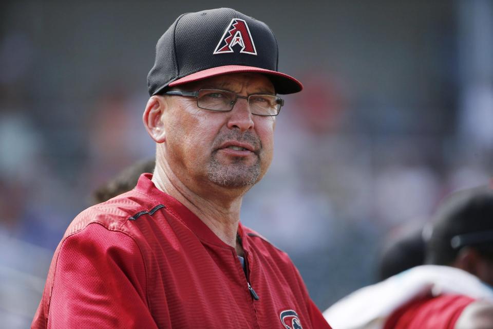In this file photo from 2015, former Arizona Diamondbacks assistant hitting coach Mark Grace watches the Diamondbacks players during the fourth inning of a spring training baseball game against the Cincinnati Reds Wednesday, April 1, 2015, in Goodyear, Ariz.