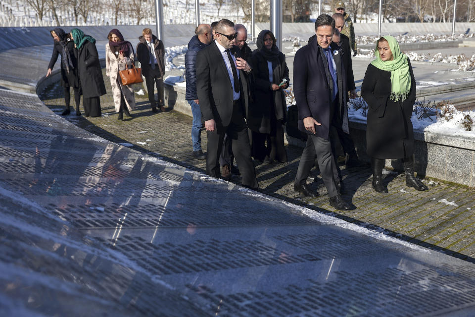 Prime Minister of the Netherlands, Mark Rutte, second from right, walks next to the monument with names of those killed in Srebrenica genocide at the Srebrenica Memorial Center in Potocari, Bosnia, Monday, Jan. 22, 2024. (AP Photo/Armin Durgut)