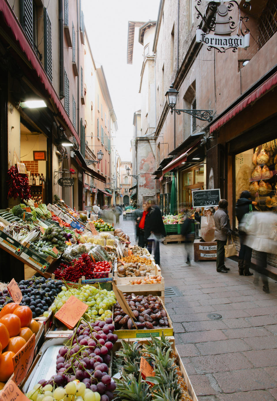 Traditional food shops in narrow cobbled street.