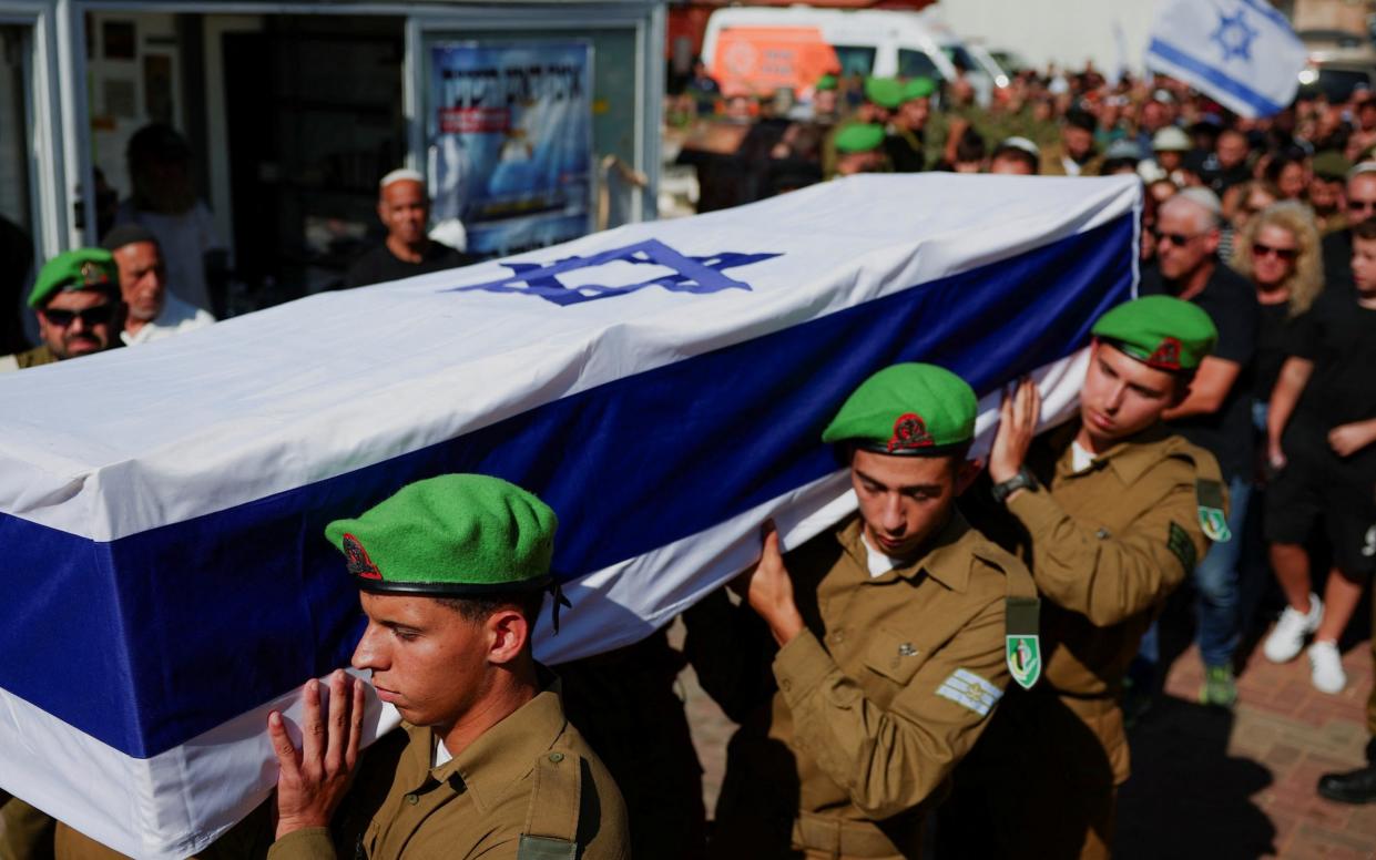 Israeli soldiers carry the coffin of First Sergeant Amit Friedman, who was killed amid the ongoing conflict in Gaza