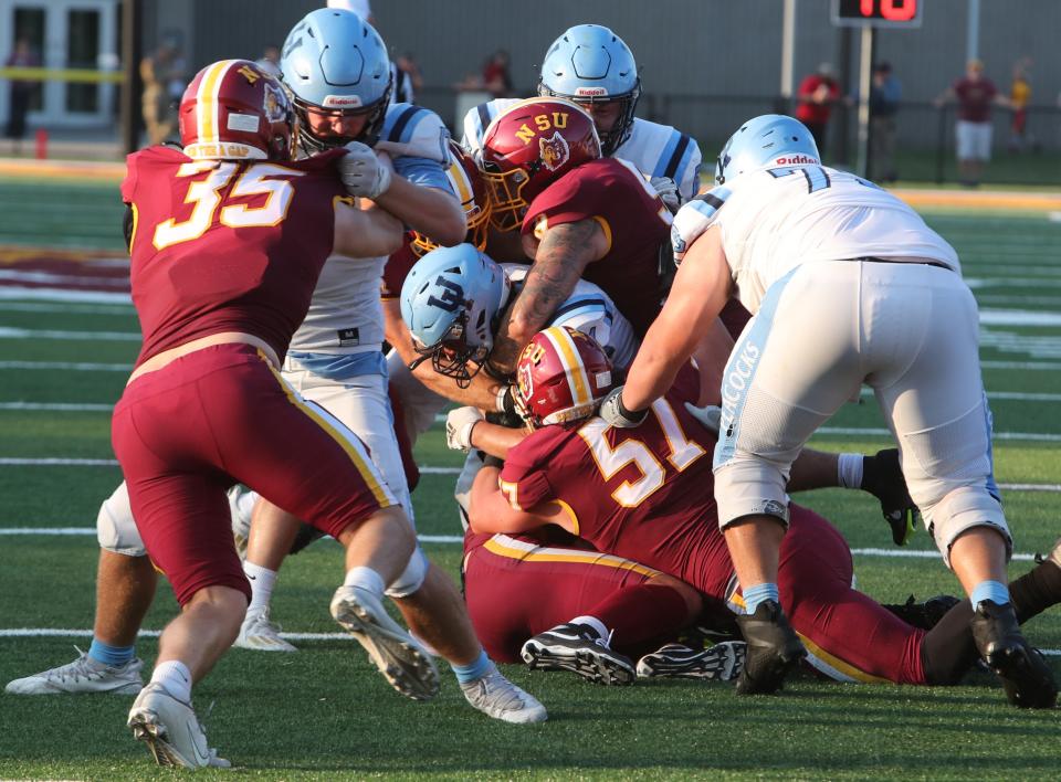 The Northern State University defense suffocates an Upper Iowa rusher in the first half of the Wolves' 30-0 vehicle Thursday night at Dacotah Bank Stadium.