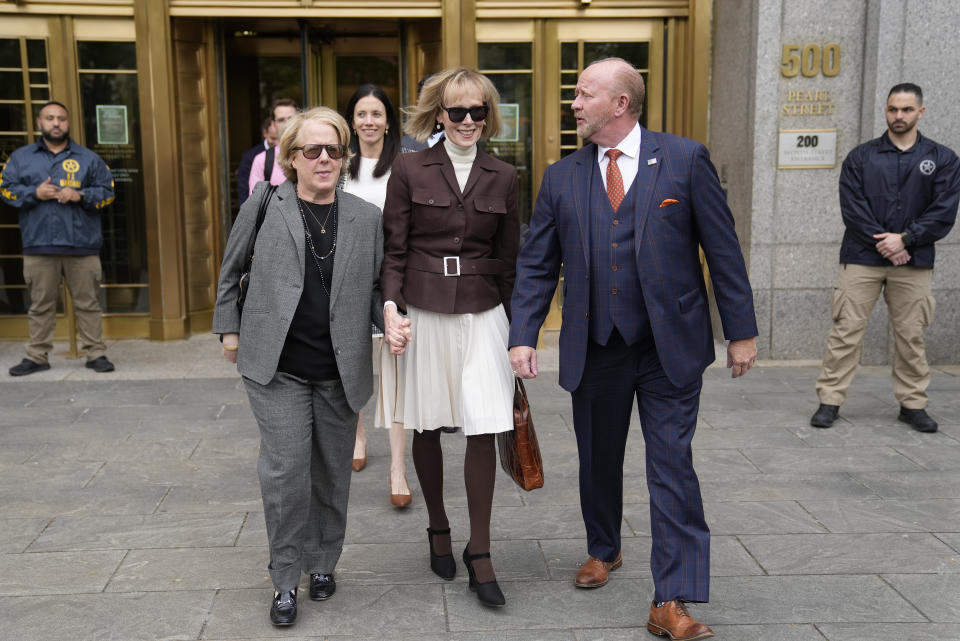 CORRECTS DATE TO MAY 9, 2023 - E. Jean Carroll, center, walks out of Manhattan federal court, Tuesday, May 9, 2023, in New York. A jury has found Donald Trump liable for sexually abusing the advice columnist in 1996, awarding her $5 million in a judgment that could haunt the former president as he campaigns to regain the White House. (AP Photo/John Minchillo)